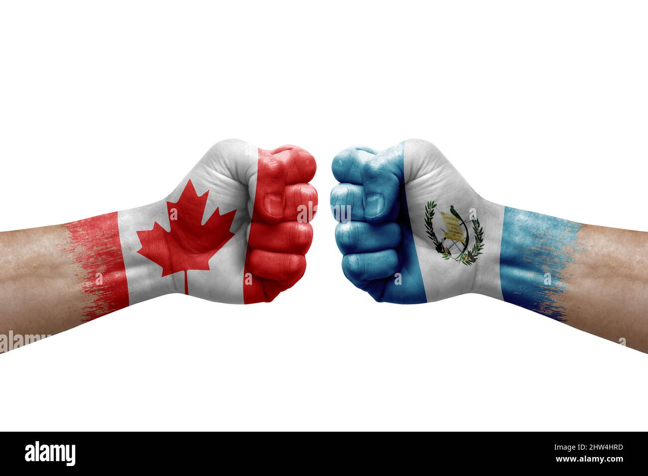 Two hands punch to each others on white background. Country flags painted fists, conflict crisis concept between canada and guatemala Stock Photo