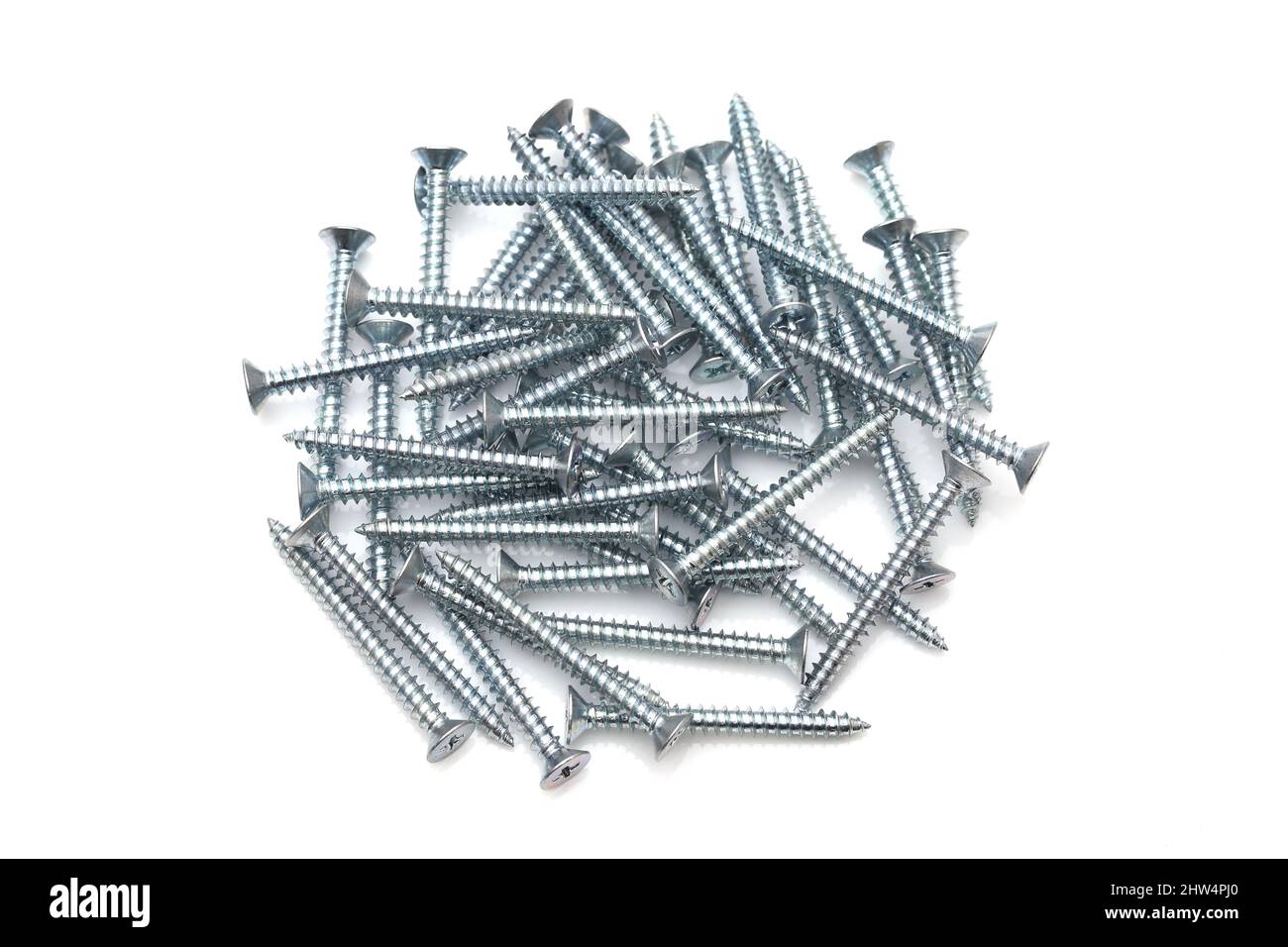 Pile of silver tapping screws isolated on white background Stock Photo