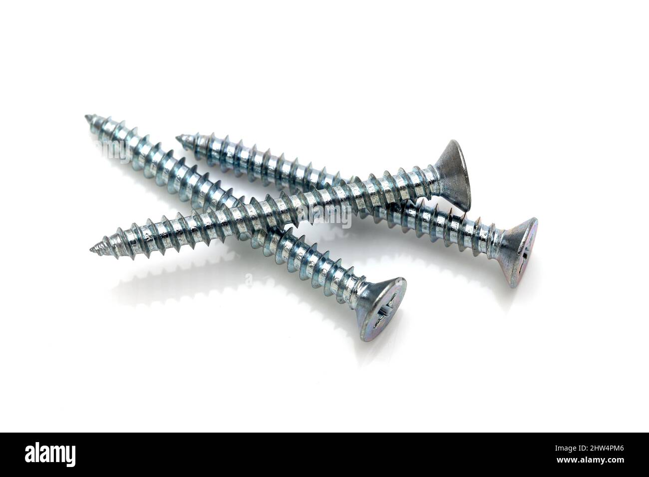 silver metallic tapping screws on white background Stock Photo