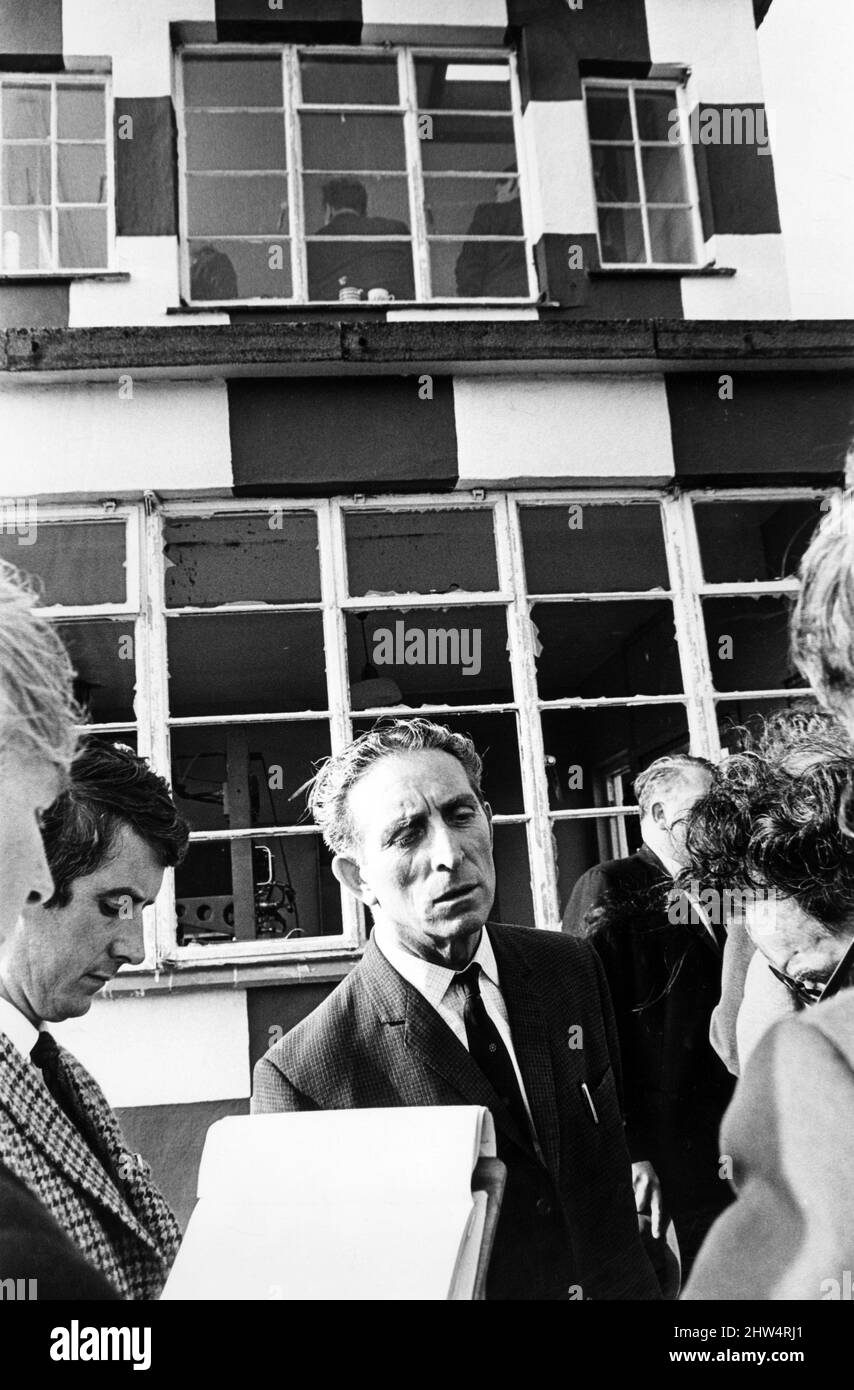 The Secretary of State for Wales, Mr George Thomas talking to press and television reporters at the scene of a bomb explosion in the control tower of a practice bombing range at Pembrey, Carmarthenshire. The shattered windows of the control tower can be seen behind Mr Thomas. 9th September 1968. Stock Photo