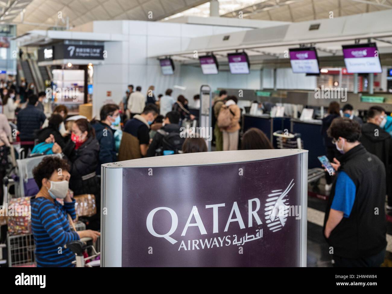 Hong Kong, China. 16th Feb, 2022. Flight passengers of state-owned flag carrier of Qatar, Qatar Airway, are seen lining up at a check-in desk in Hong Kong international airport as most businesses are shutdown due to the covid-19 variant spread. (Credit Image: © Budrul Chukrut/SOPA Images via ZUMA Press Wire) Stock Photo