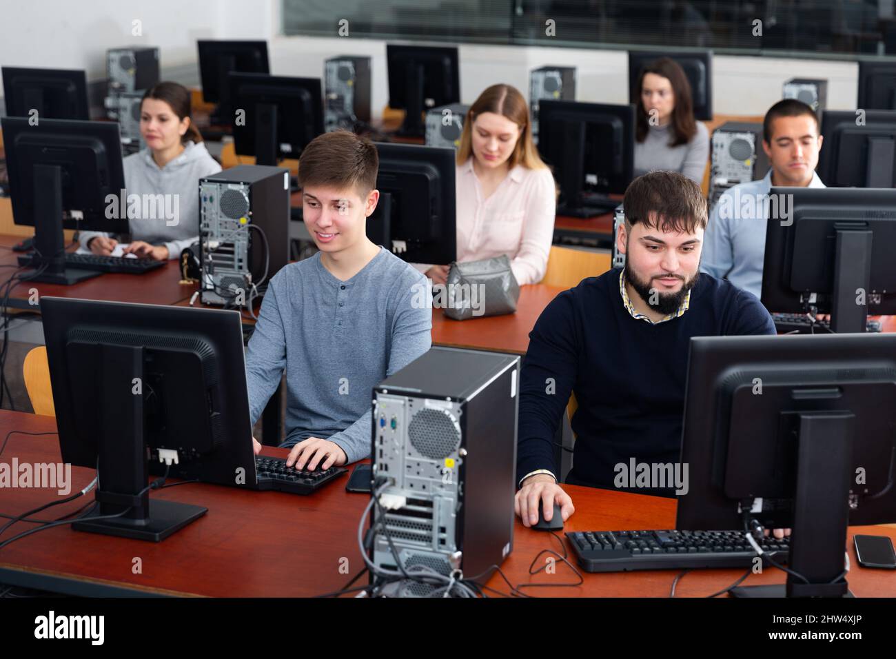 Group of people learning to use computers in classroom Stock Photo - Alamy