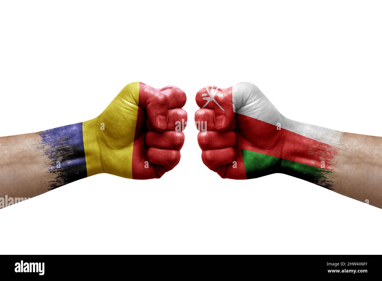 Two hands punch to each others on white background. Country flags painted fists, conflict crisis concept between chad and oman Stock Photo