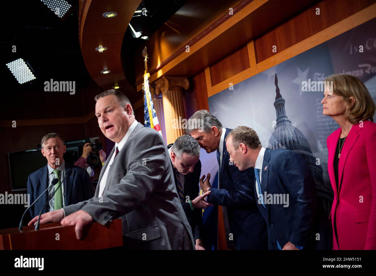 United States Representative Brian Fitzpatrick (Republican of Pennsylvania), third from left, confers with United States Senator Joe Manchin III (Democrat of West Virginia), third from right, and United States Representative Josh Gottheimer (Democrat of New Jersey), second from right, during a news conference about a bill to ban Russian energy imports, at the US Capitol in Washington, DC, Thursday, March 3, 2022. Credit: Rod Lamkey/CNP /MediaPunch Stock Photo