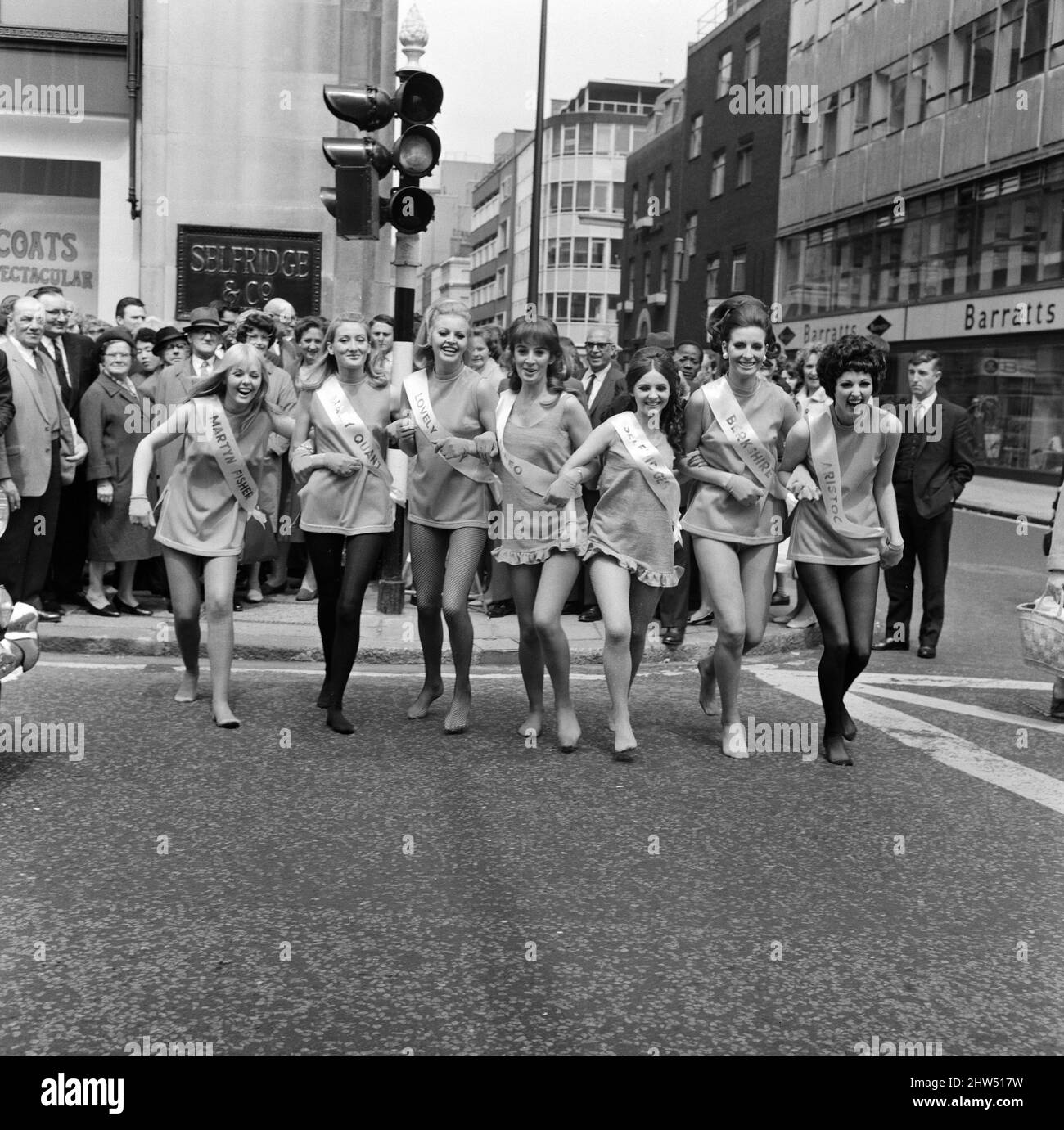 London stores are holding a shopping festival, the 'Britain is Great' exhibition. In Selfridges there was a 'charge of the tight' brigade' where seven lovely ladies with lovely legs appeared representing famous hosiery manufacturers.  The girls walking down Oxford Street. 23rd May 1968. Stock Photo