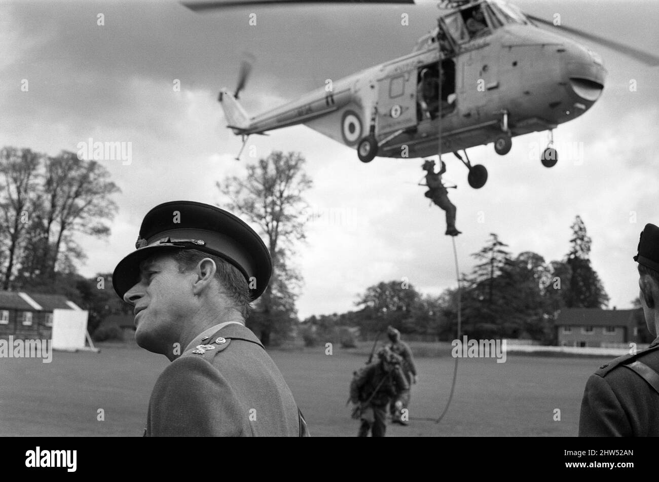 Prince Philip, Duke of Edinburgh, visiting the Infantry Junior Leaders Battalion at Park Hall Camp, Oswestry, Shropshire. In camouflaged battledress and camp's boy soldiers do an airborne cavalry exercise on the cricket field. In squads of six they run to RAF Whirlwind helicopters and are whisked off. A quick flight round the camp and the helicopters are once again over the cricket field. The boys, all aged between 15 and 17 disembark by ropes as the machines over 20ft above the ground. 26th May 1967. Stock Photo