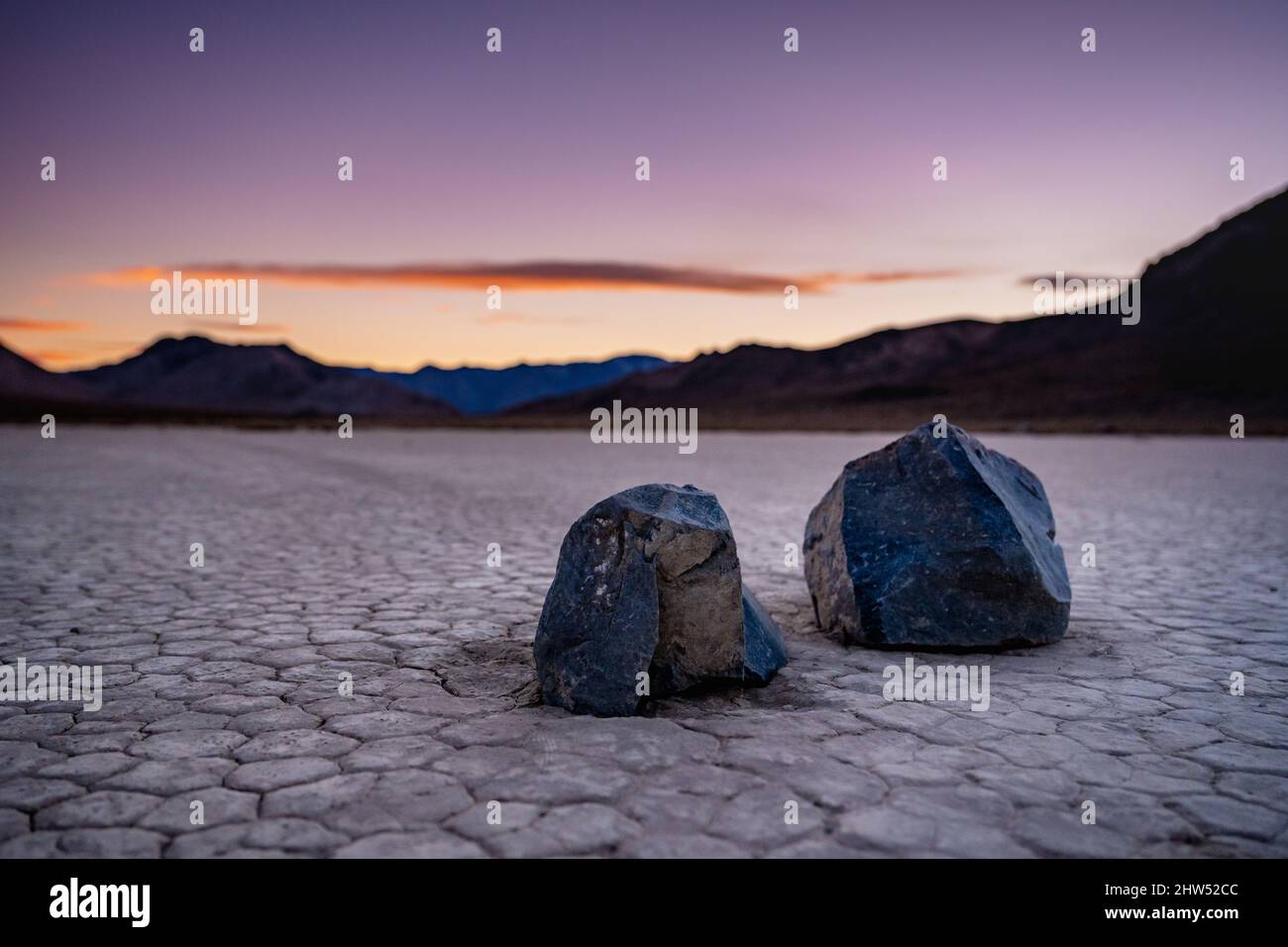 Low Angle of Two Sharp Sailing Stones At Sunset in Death Valley Stock Photo