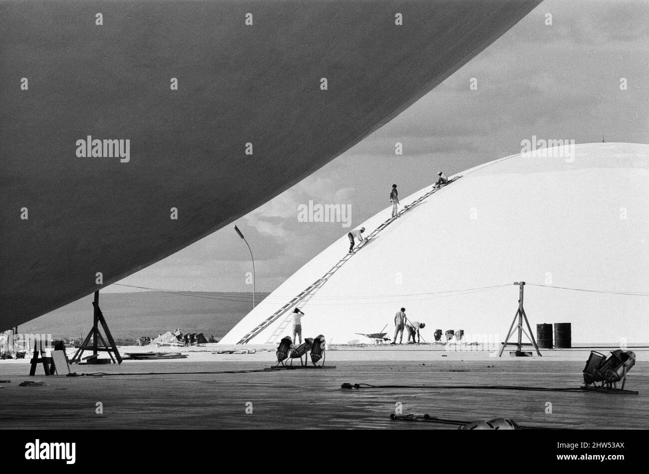 The palace of the National Congress, under construction, Brasilia , Brazil, 1st November 1968.  Plaza of the Three Powers government buildings designed by Oscar Ribeiro de Almeida Niemeyer Soares Filho, known as Oscar Niemeyer.   Rising above the flat roof, are two cupolas,  which indicate the assembly chambers of Brazil's bicameral legislature. Stock Photo