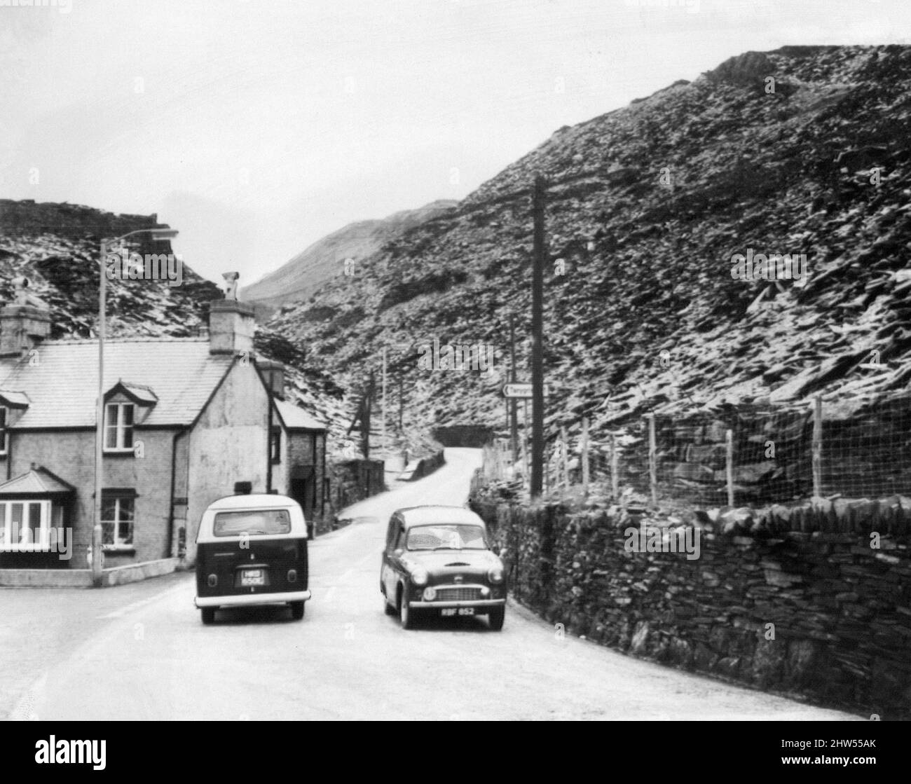 Blaenau Ffestiniog is a historic mining town in the historic county of Merionethshire, Wales, 7th September 1967.  Our Picture Shows ... the main road from Blaenau Ffestiniog to the Crimea Pass, cutting through the mountain of slate spoil where a  seeding experiment is taking place. Stock Photo