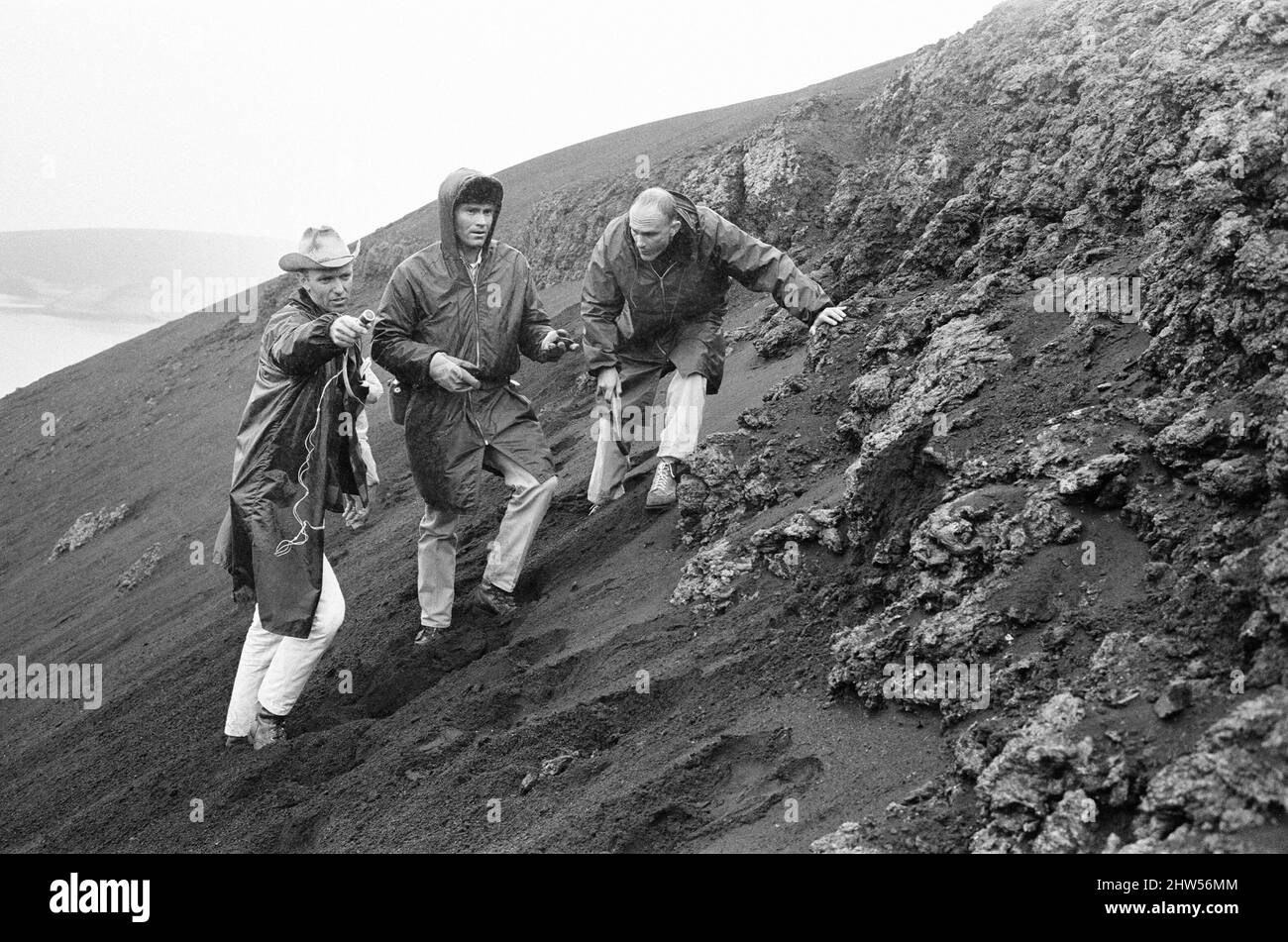 21 NASA Astronauts have just spend a week in Iceland, making a study of the Geology of the Island, which is the nearest one can get to moonscape conditions on Earth, Sunday 9th  July 1967. Two of these twenty-one are likely to be the first earthmen to walk on the surface of the moon, which will climax America's 7000 million Apollo programme.  Our picture shows ... Three astronauts climbing over a lava hill, left to right, Joe Engle, Fred Haise and Ken Mattingly. Stock Photo