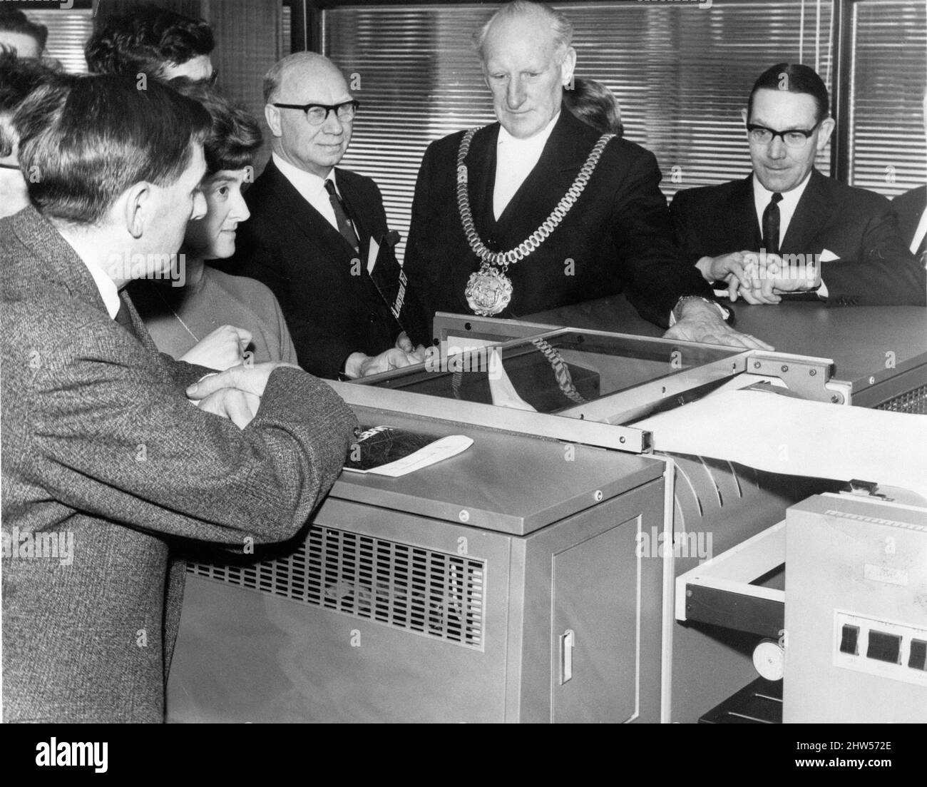 Liverpool Corporation's new assistant, a three hundred thousand computer, makes its debut when the Lord Mayor of Liverpool, Alderman Herbert Allen put the machine into operation by pressing a button, 19th April 1967. Also pictured are, Alderman David Cowley (left) and Mr J L Salt (city treasurer) right.  The computer, housed in a special air conditioned room in Commerce House, Sir Thomas Street, will eventually play a major role in the lives of Liverpool people, dealing with such differing subjects as rate records  and child vaccination. Stock Photo