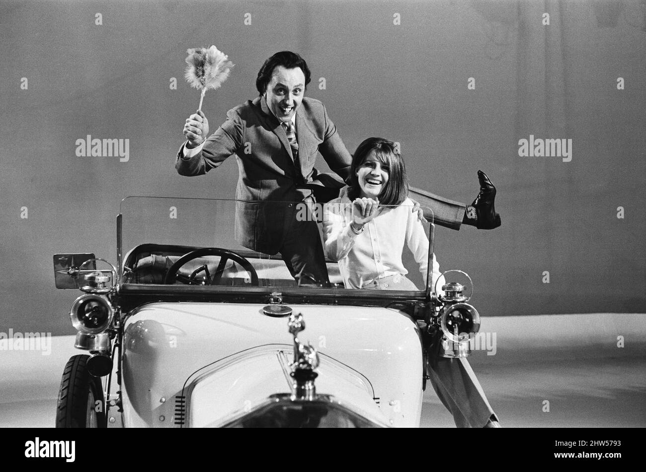 Sandie Shaw and Ken Dodd appear on the ABC Television Show 'Doddy's Music Box.' They are pictured in the 1912 Rover car used in the show, which is filmed in Didsbury, Manchester. 24th January 1967. Stock Photo