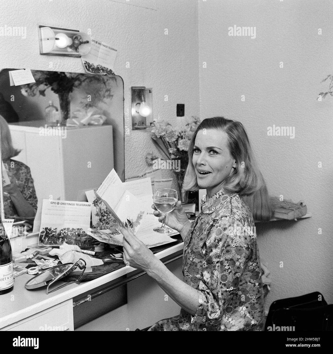 Actress Honor Blackman reads telegrams of congratulations in her