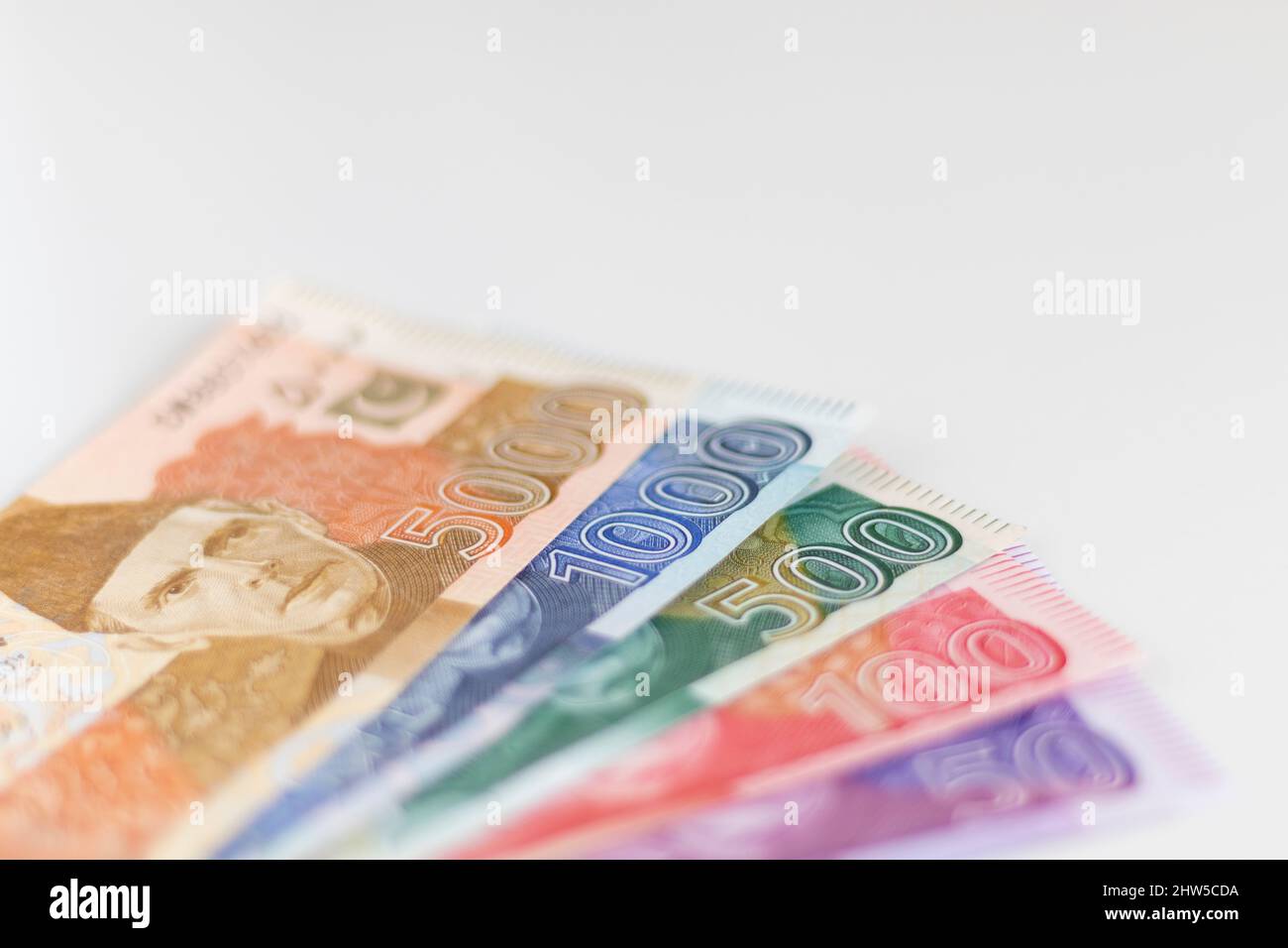 Multiple denomination bank notes on isolated white background Stock Photo