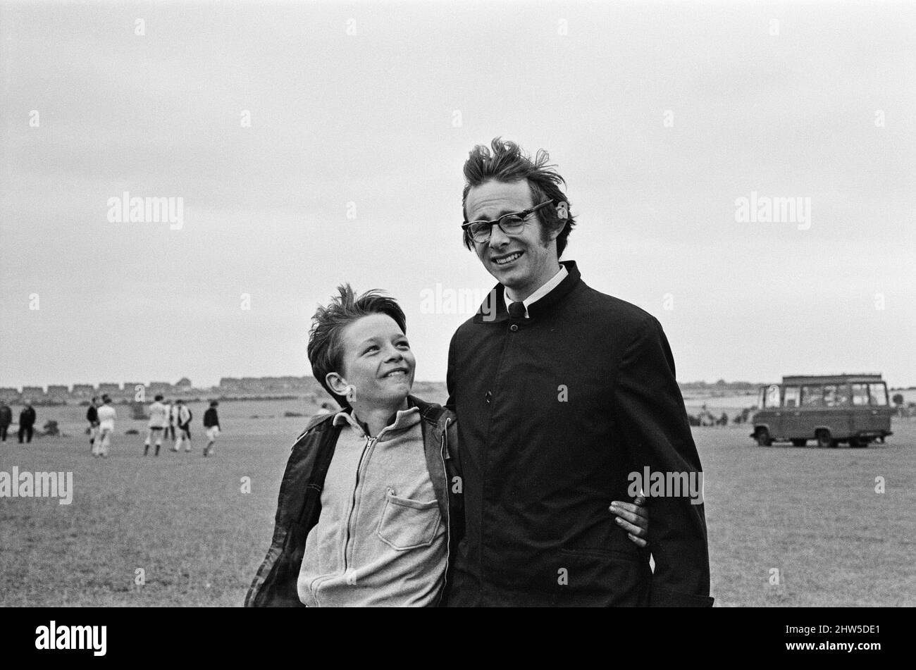 Ken Loach, (film director) on the school football playing field, during the filming of the football scene in the film Kes. Here he is pictured with David Bradley, (aged 14) plays the part of Billy Casper.  Kes is a 1969 release drama film directed by Ken Loach and produced by Tony Garnett. The film is based on the 1968 novel A Kestrel for a Knave, written by the Barnsley-born author Barry Hines. The film is ranked seventh in the British Film Institute's Top Ten (British) Films and among the top ten in its list of the 50 films you should see by the age of 14.     The film was shot on location a Stock Photo