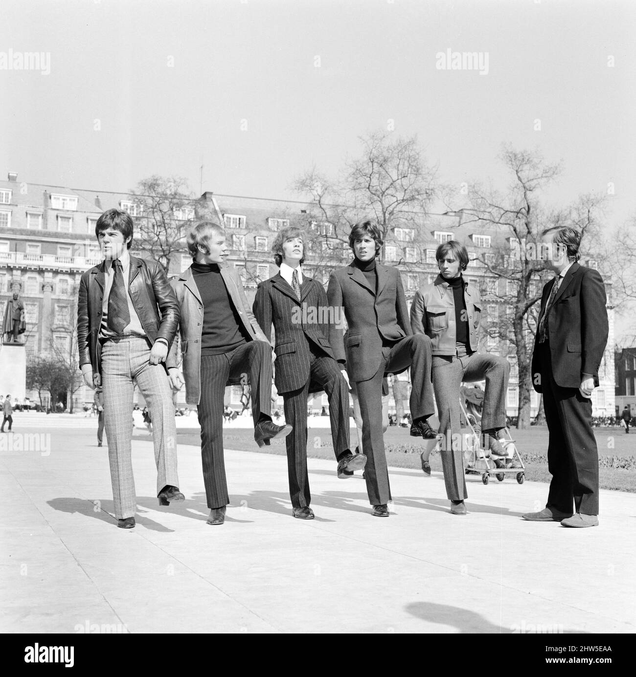 The Bee Gees are put through their paces by Britain's top comedy writer Johnny Speight, who will be writing the screenplay for their first full length feature film 'Lord Kitchener's Little Drummer Boys'. The plot concerns the press ganging of the boys to join the army as bandsmen during the Boer War, filming starts later this year.  Johnny marches The Bee Gees through London as he gives them a taste of what's to come 29th March 1968.  Pictured (l to r) Vince Melouney, Colin Peterson, Robin Gibb, Barry Gigg & Maurice Gibb with Johnny Speight Stock Photo