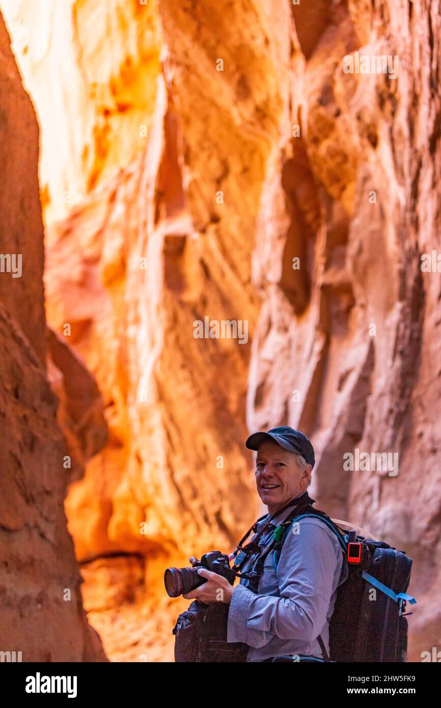 United States, Utah, Escalante, Senior hiker exploring and photographing rock formations in Kodachrome Basin State Park nearÂ EscalanteÂ Grand Staircase National Monument Stock Photo