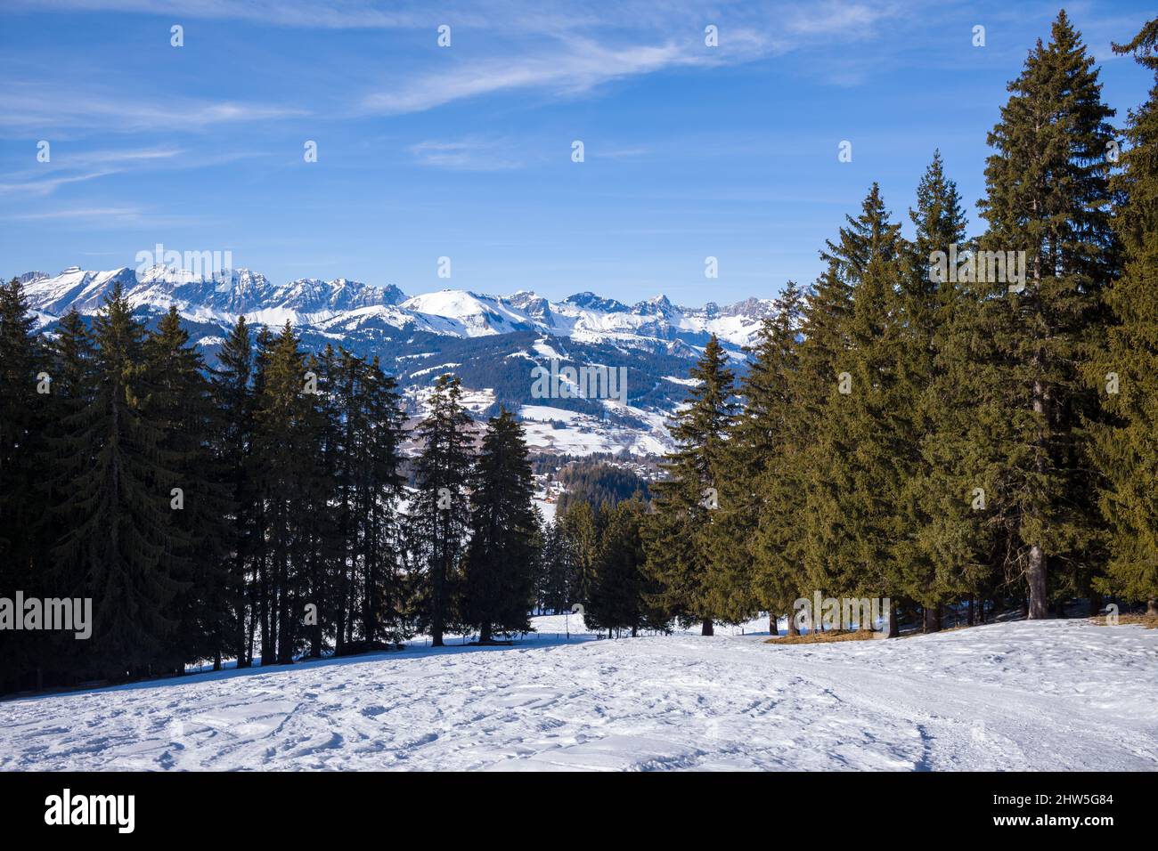 This landscape photo was taken in Europe, in France, Rhone Alpes, in Savoie, in the Alps, in winter. We see the Chaine des Aravis in the forests of th Stock Photo
