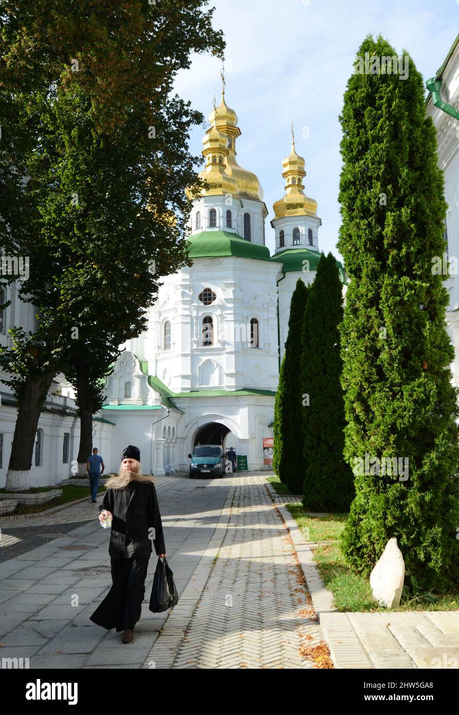 A Ukrainian Orthodox priest walking by the Lavra monastery in Kyiv, Ukraine. Stock Photo