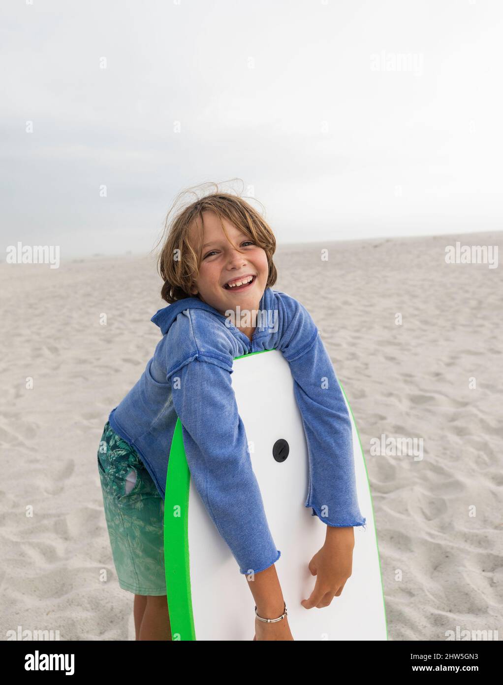 Boy (8-9) with body board on Grotto Beach Stock Photo