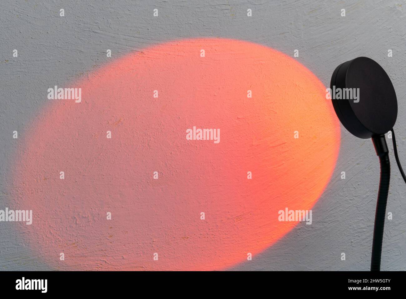 Sunset projector lamp. Multi colored RGB light. Home decor. Copy space Stock Photo