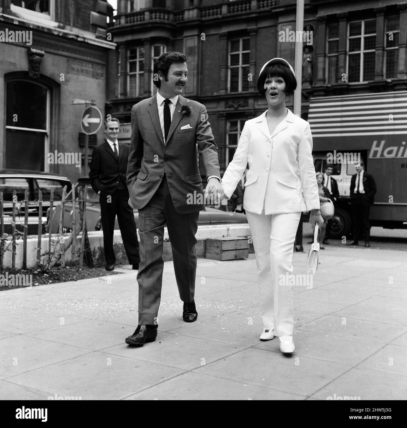 When actor Robin Hunter was married today at Caxton Hall his actress bride Amanda Barrie wore a suit too. Hers was in white linen with a white matching hat. Amanda said jokingly 'But Robin will wear the trousers in our marriage.' 19th June 1967. Stock Photo