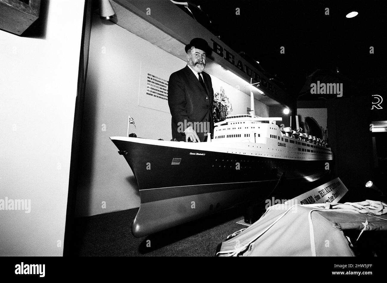 Captain William Warwick the new master of the Cunard liner the Queen Elizabeth 2 alongside the model being displayed at the International Boat Show at Earls Court, London. 2nd January 1968. Stock Photo