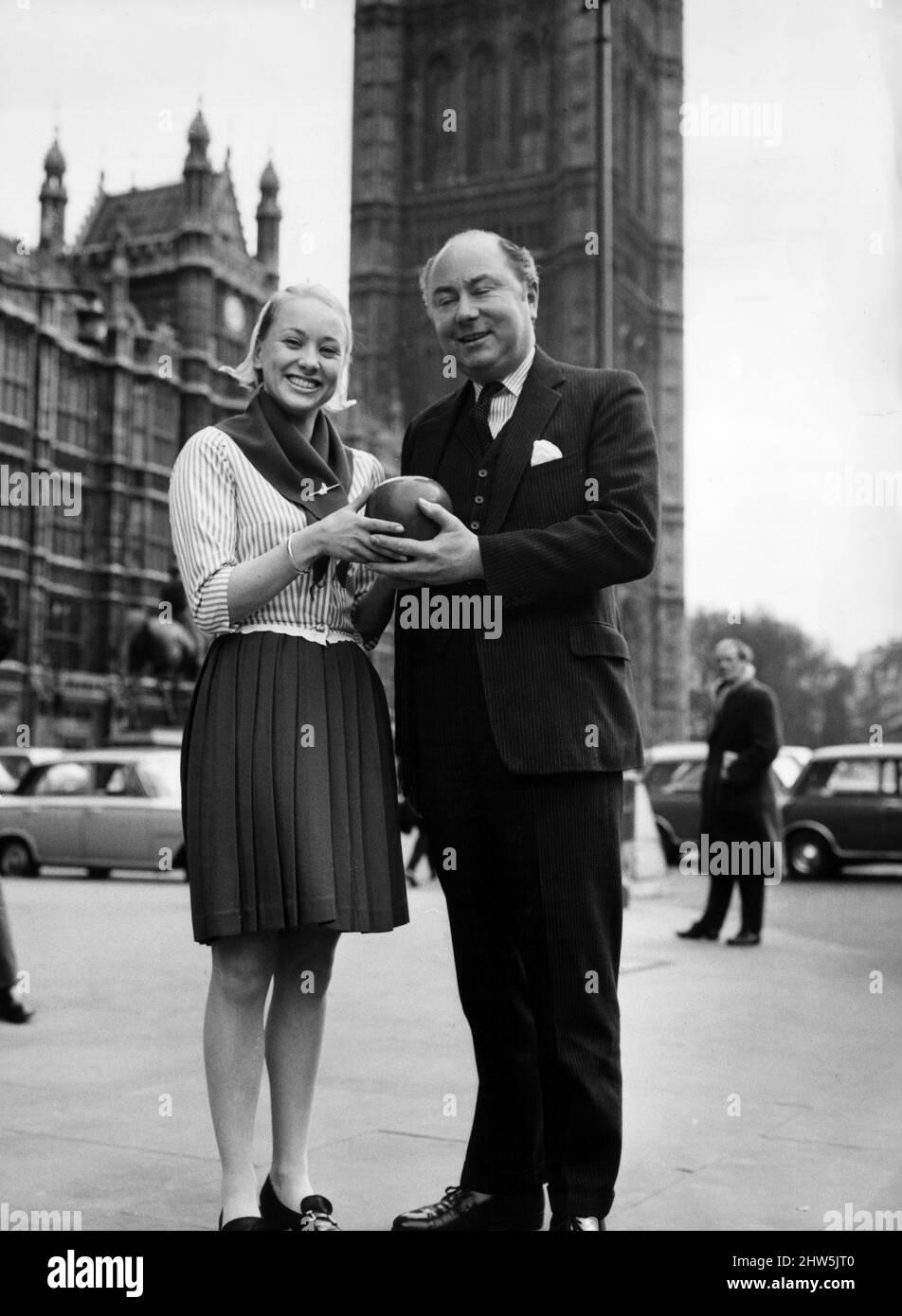William van Straubenzee, Member of Parliament for Wokingham, is presented with a dutch edam cheese from Annelieu Van Der Giessen, outside the Houses of Parliament, London, after he complained that there were no foreign cheeses available to members in the dining rooms, pictured 5th March 1968. Stock Photo