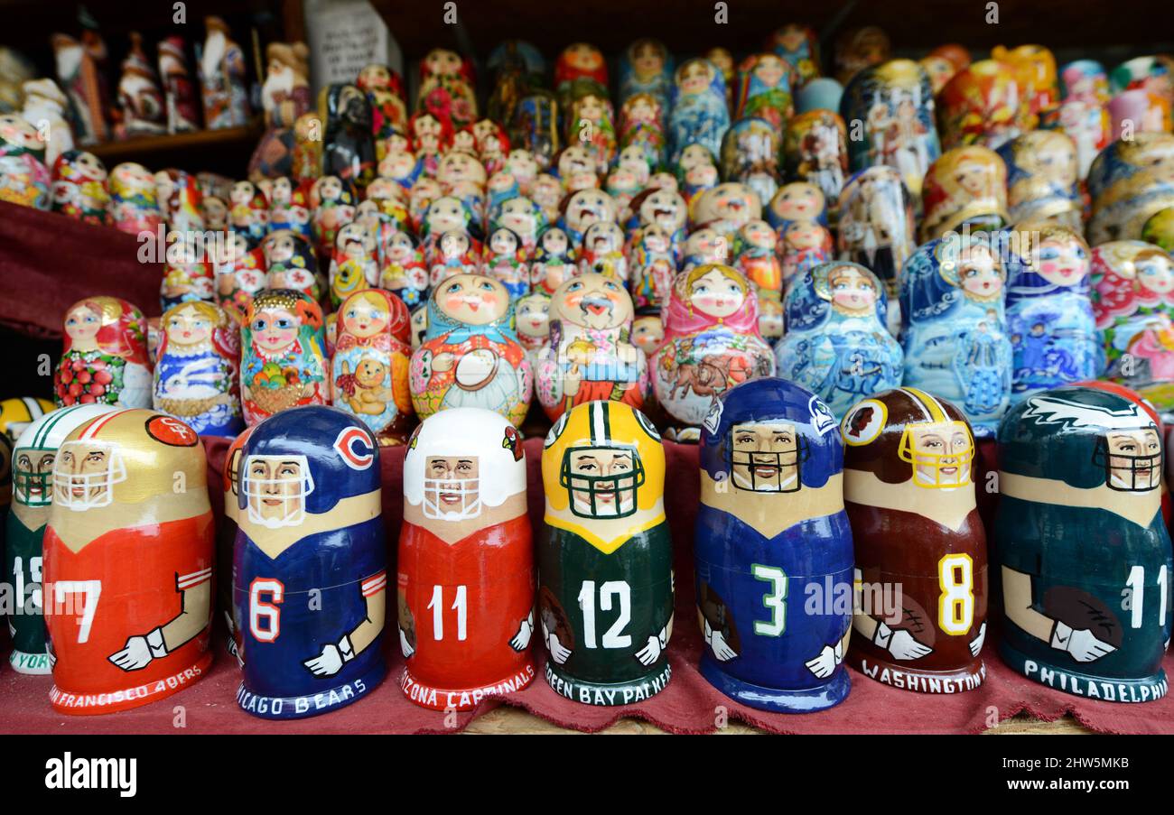 Traditional and modern Matryoshka dolls displayed by an artist in his stall on Andriivs'kyi descent in Kyiv, Ukraine. Stock Photo