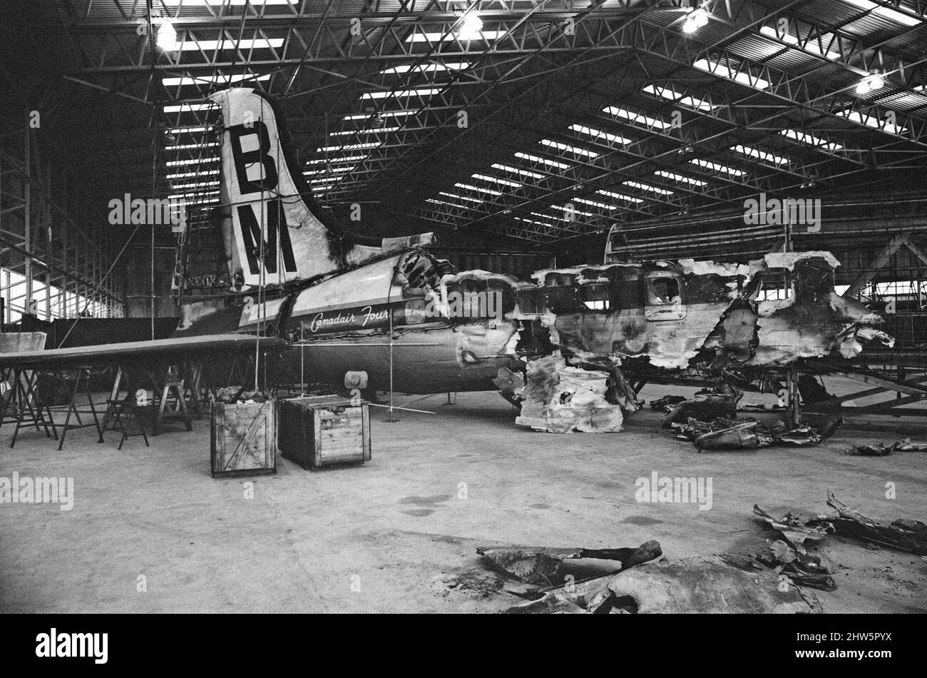The wreckage of his British Midland plane, now at Farnborough Aerodrome.Captain Marlow Survived the Stockport air crash of 4th June 1967, and is in other frames in this set.  The Stockport air disaster was the crash of a Canadair C-4 Argonaut aircraft owned by British Midland Airways, registration G-ALHG,[1] in a small open area at Hopes Carr near the centre of Stockport, Cheshire, England on Sunday 4 June 1967. 72 of the 84 aboard were killed in the accident. Of the 12 survivors, all were seriously injured. It currently stands as the fourth worst disaster in British aviation history, and the Stock Photo