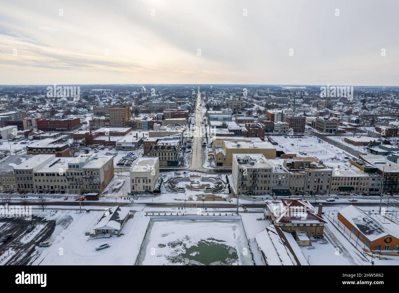 Aerial view of a city with mid-rise buildings covered in snow on a cold ...