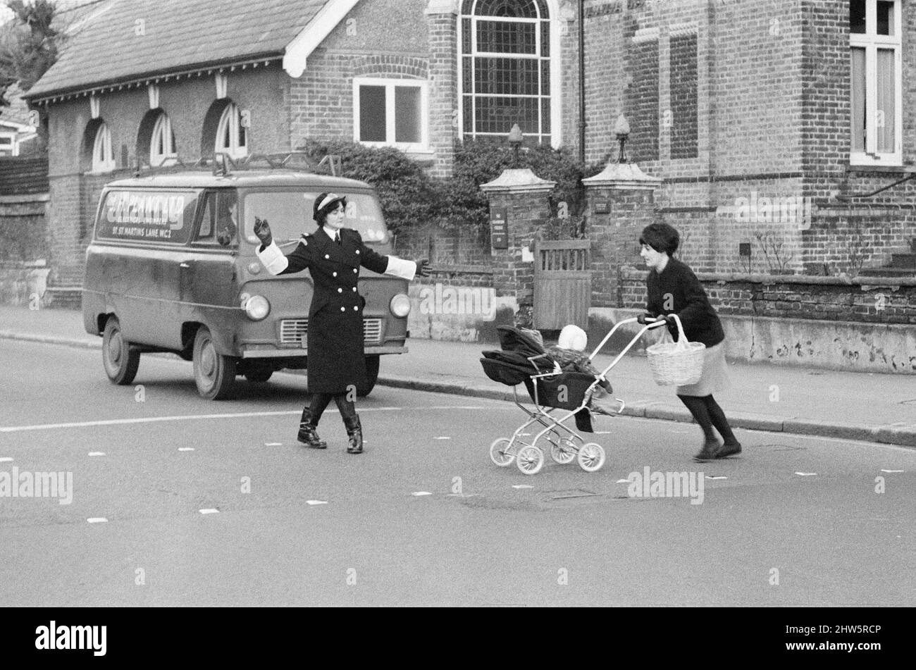 Britain's first Traffic Warden to control traffic as opposed to booking cars for parking offences, Mrs Joyce Roffey, on point duty at a busy crossroads in Croydon, Surrey, the junction of Park Lane and Coombe Road, 2nd January 1967. Stock Photo