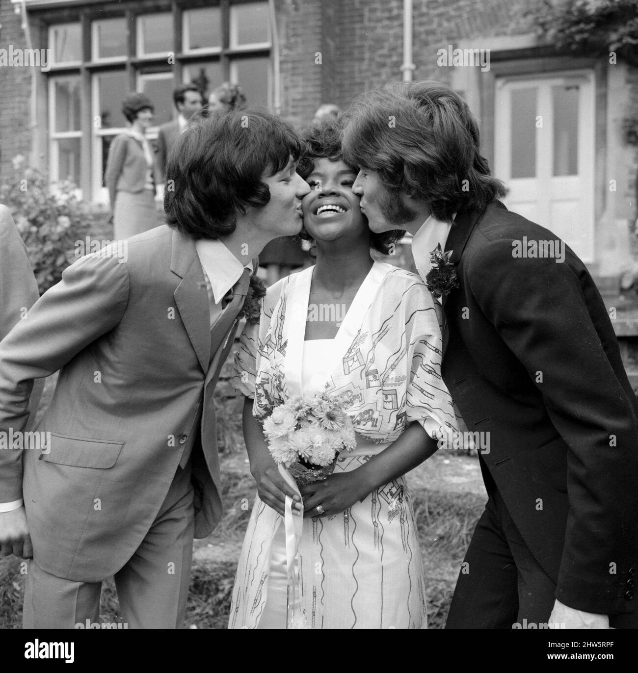 American Pop singer P.P. Arnold receives a kiss from  her new husband, manager Jim Morrison (left) and Barry Gibb of the Bee Gees pop group on her wedding day  October 1968 Stock Photo