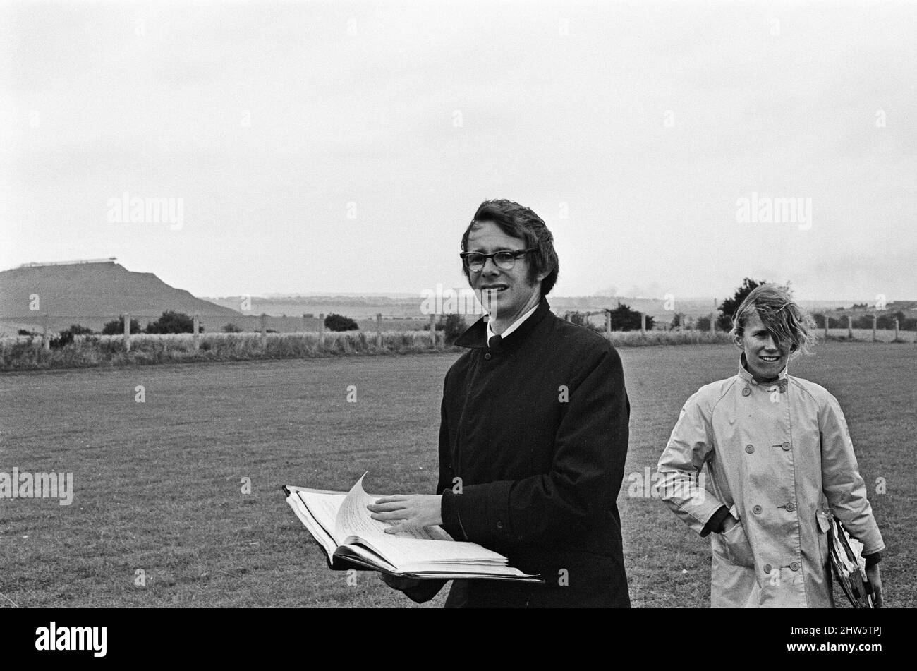 Ken Loach, (film director) on the school football playing field, during the filming of the football scene in the film Kes. David Bradley, (aged 14) plays the part of Billy Casper, pictured with his Kestral, on the film set of the film Kes.     Kes is a 1969 release drama film directed by Ken Loach and produced by Tony Garnett. The film is based on the 1968 novel A Kestrel for a Knave, written by the Barnsley-born author Barry Hines. The film is ranked seventh in the British Film Institute's Top Ten (British) Films and among the top ten in its list of the 50 films you should see by the age of 1 Stock Photo