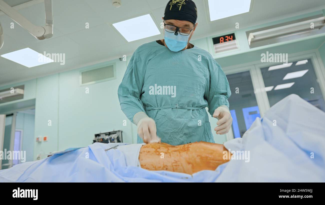 Medical team performing surgical operation in modern operating room ...