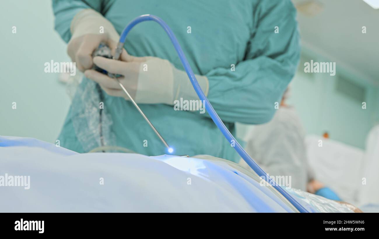 Medical team performing surgical operation in modern operating room ...