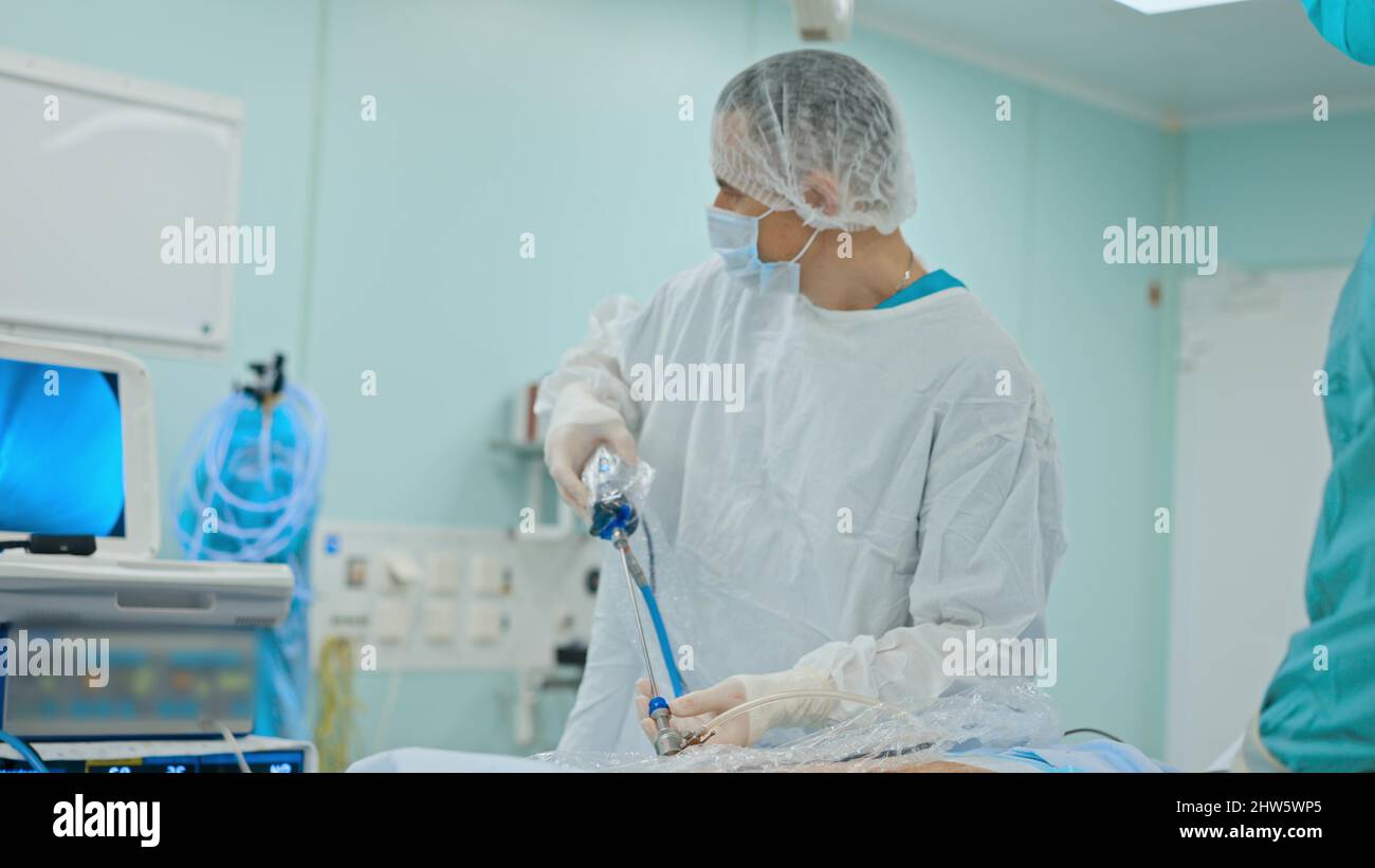Medical team performing surgical operation in modern operating room ...