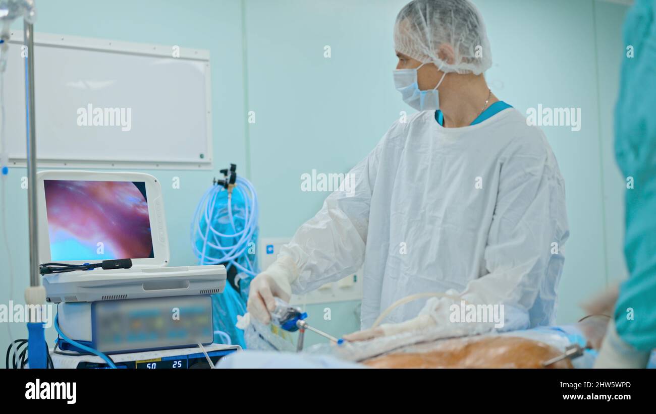 Medical team performing surgical operation in modern operating room ...