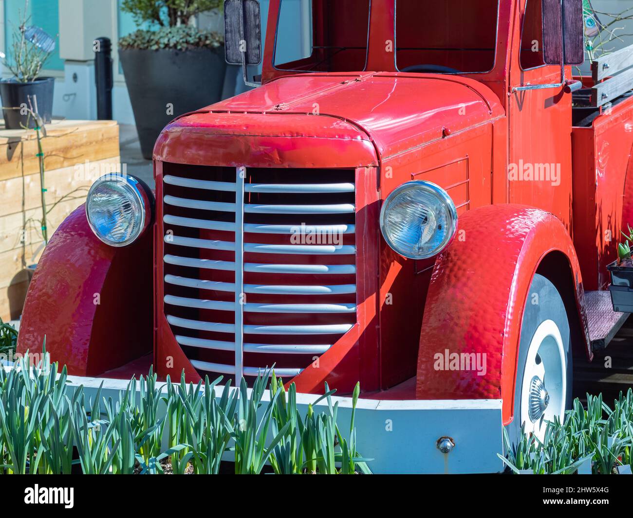 View of the front end of a beautifully restored vintage truck automobile. Old vintage American red pickup car front side Stock Photo