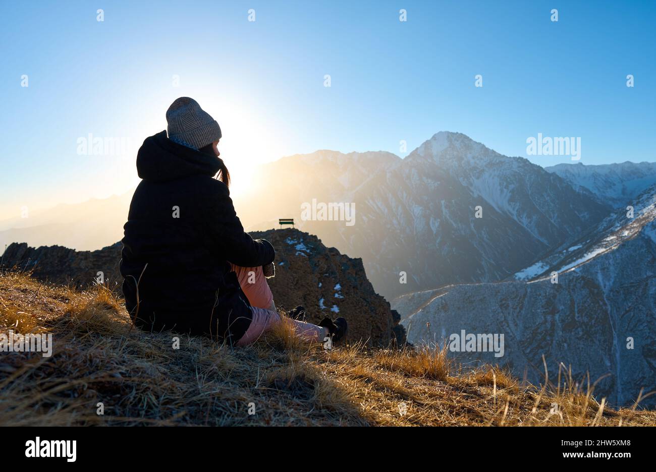 Beautiful girl sitting on mountain top hi-res stock photography and ...