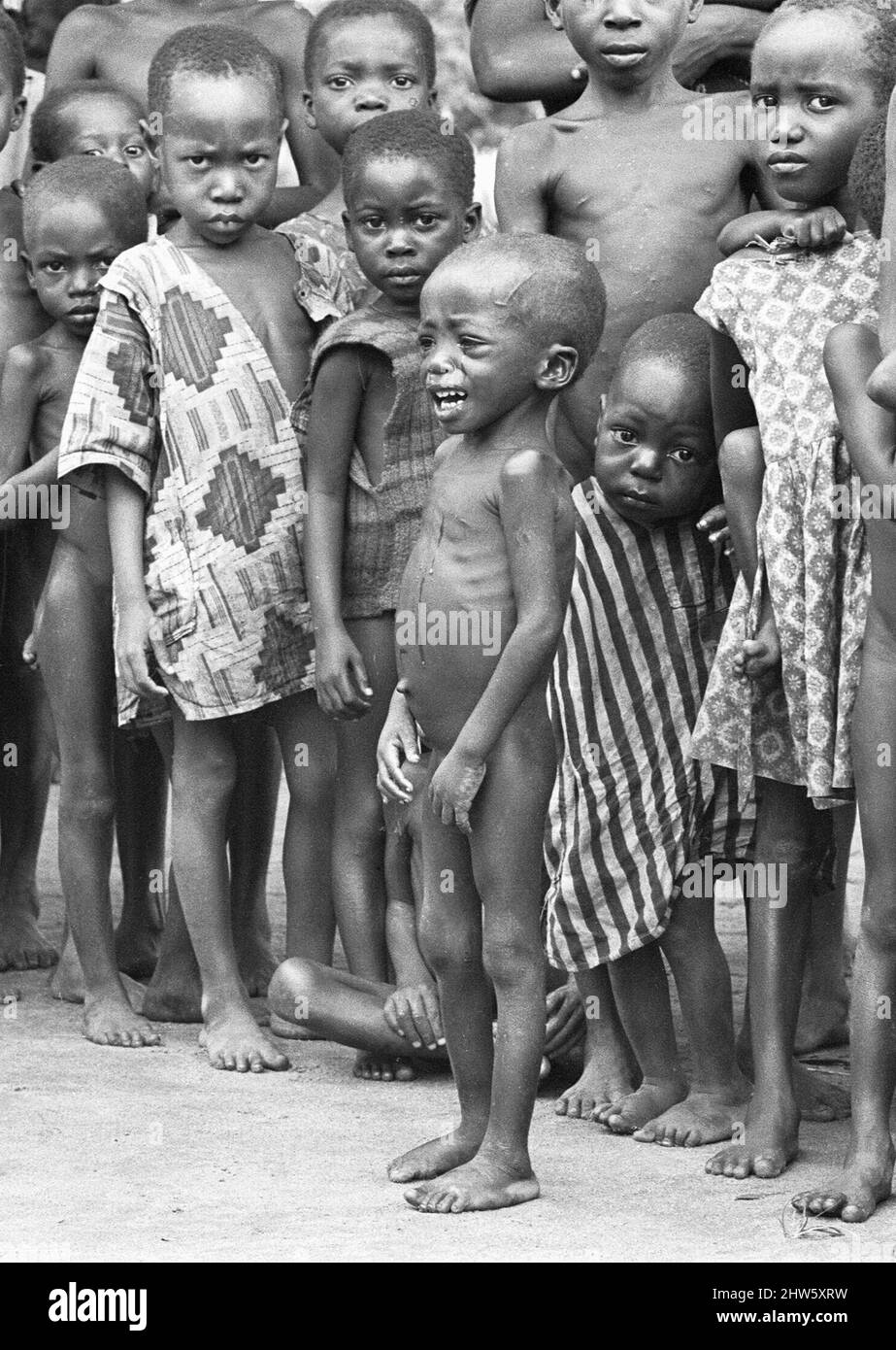 Starving children at the Queen Elizabeth Hospital, Umuahia just a few of the estimated one to two million victims of the Biafran War. 23rd June 1968The Nigerian Civil War, also known as the Biafran War endured for two and a half years, from  6 July 1967 to 15 January 1970, and was fought to counter the secession of Biafra from Nigeria. The indigenous Igbo people of Biafra felt they could no longer co-exist with the Northern-dominated federal government following independence from Great Britain. Political, economic, ethnic, cultural and religious tensions finally boiled over into civil war foll Stock Photo