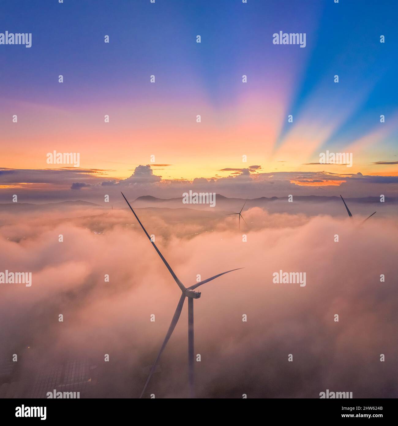 Aerial view of windmill or wind farm in fog  at Cau Dat town, Da Lat city, Lam Dong, Vietnam Stock Photo