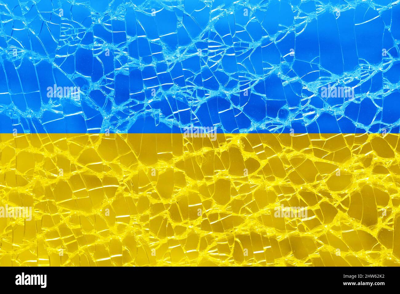flag of ukraine on broken glass background Stock Photo