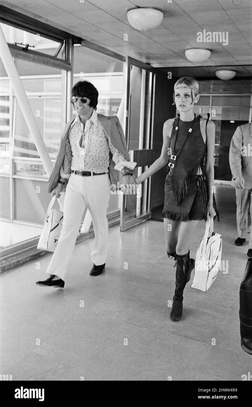 Twiggy, (real name Leslie Hornby) English model, seen in a Hippie gear outfit leaving London Heathrow airport on TWA for New York, America.  Pictured with her boyfriend and model Justin de Villeneuve.See also X7903 picture set of Twiggy modelling earlier the same day, in the same outfit.  Twiggy said of her Hippie outfit, 'I Love it !   I have a Hippie hat, it's straw with poppies on the side.  But I couldn't wear it today because it doesn't go with this outfit.  That shows I'm not a real Hippie doesn't it ?  If I was, I'd wear it anyway wouldn't I ? ' she goes on to say 'I think the clothes c Stock Photo