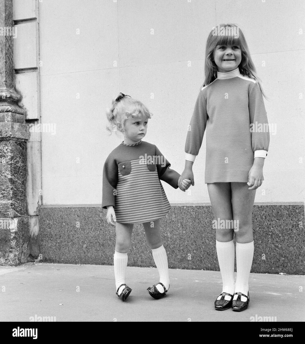 Tick a Tee Clothing manufacturer has designed a boutique range for children, shown here modelling the clothes in Conduit Street, London, Wednesday 31st July 1968.  Our Picture Shows ... child models (left to right) Samantha Gates (3) and Dhareigne Ridley (6). Stock Photo