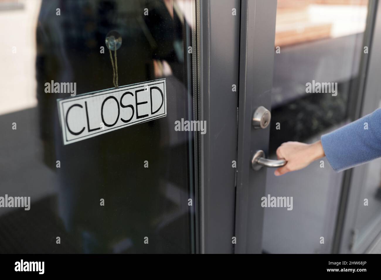 hand trying to open closed office door Stock Photo