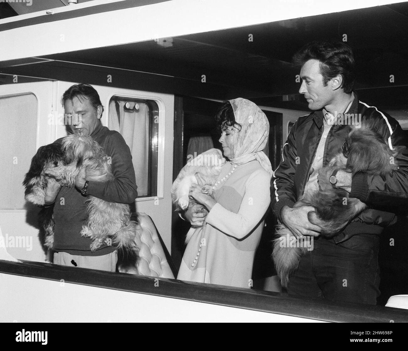Richard Burton and Elizabeth Taylor on their yacht 'Beatriz' moored off Tower Pier, London, while Richard is filming 'Where Eagles Dare'. Also onboard was co-star Clint Eastwood and the Burton dogs, which had to remain onboard in quarantine. 16th February 1968. Stock Photo