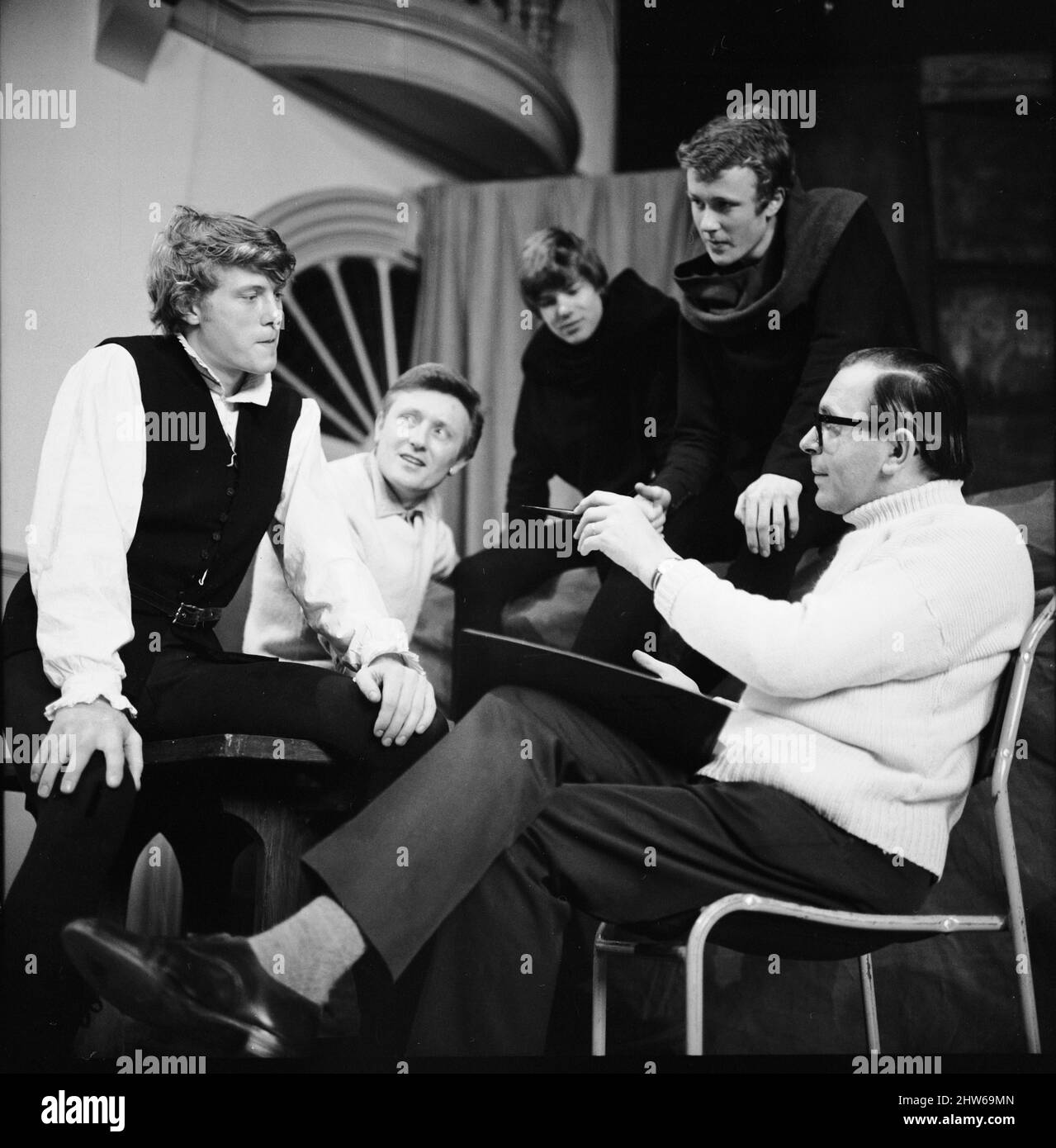 British actor and singer Gary Miller with his three children Pip (left), Jonty (centre) and Kit (2nd right) speaking with MR A S Jenkins, head of drama at Alleyn's School in Dulwich,  before their production of the famous Shakespeare play 'Hamlet'. 12th March 1967. Stock Photo