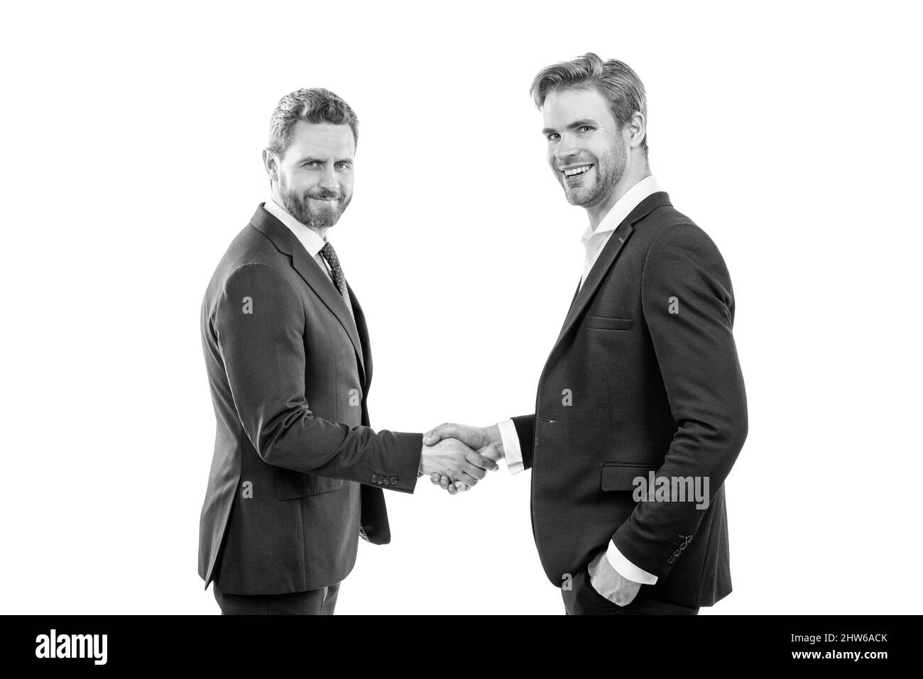 two businessmen colleagues shaking hands after successful business deal, partnership Stock Photo