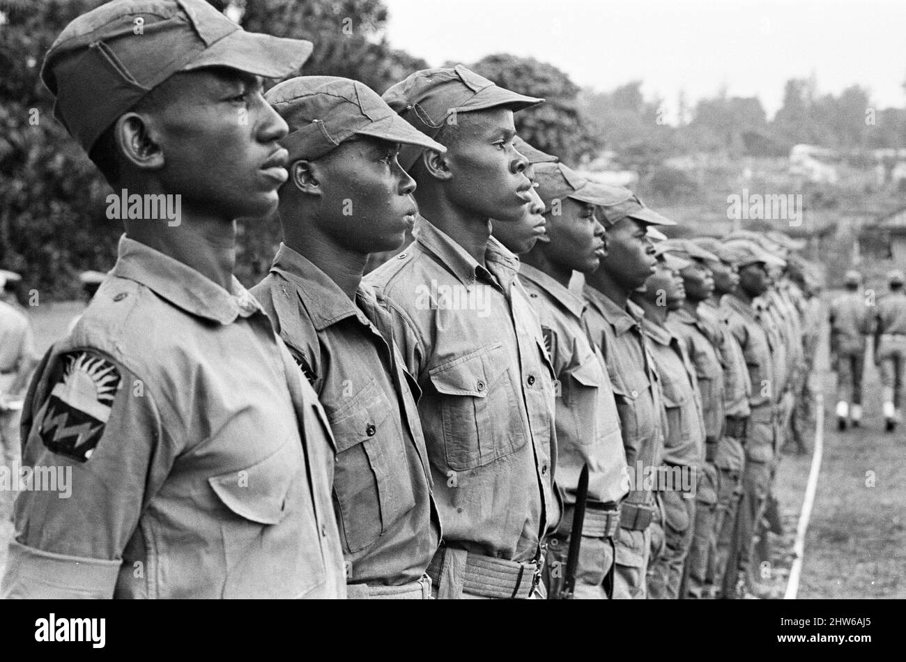 Biafran soldiers line up for inspection by Colonel Odumegwu Ojukwu, the Military Governor of Biafra in Nigeria.  11th June 1968.  The Nigerian Civil War, also known as the Biafran War endured for two and a half years, from  6 July 1967 to 15 January 1970, and was fought to counter the secession of Biafra from Nigeria. The indigenous Igbo people of Biafra felt they could no longer co-exist with the Northern-dominated federal government following independence from Great Britain. Political, economic, ethnic, cultural and religious tensions finally boiled over into civil war following the 1966 mil Stock Photo